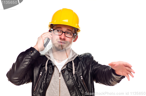 Image of Handsome Young Man in Hard Hat on Phone