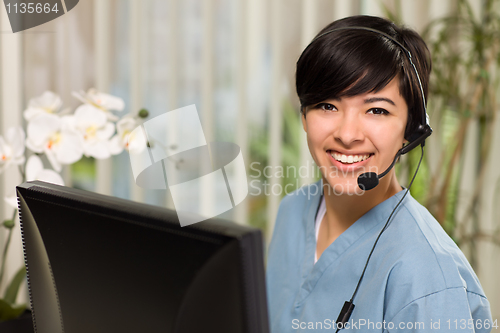 Image of Attractive Multi-ethnic Young Woman Wearing Headset and Scrubs