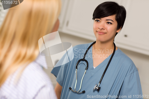 Image of Attractive Mixed Race Young Female Doctor Talking with Patient