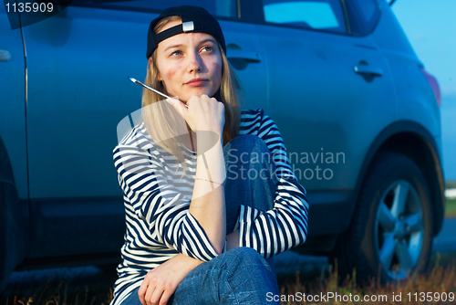 Image of Young Blond Woman With Her Broken Car