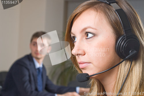 Image of Beautiful business woman with headset