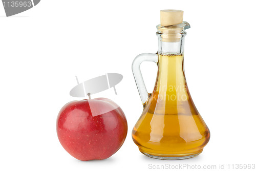 Image of Decanter with apple vinegar and red apple