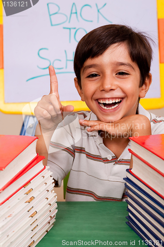 Image of Smiling young student pointing up