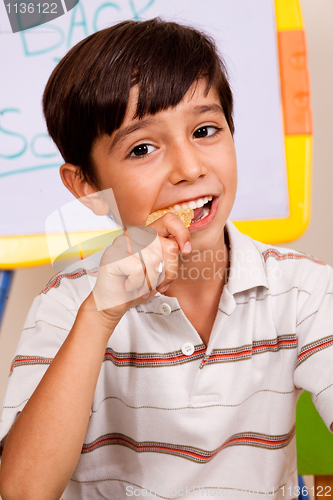 Image of School boy enjoying his lunch meal