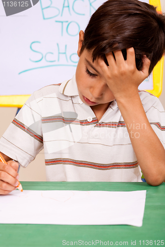 Image of Little boy has troubles with homework