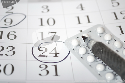 Image of Birth control pills and pen closeup