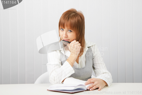 Image of business girl with notebook and pen