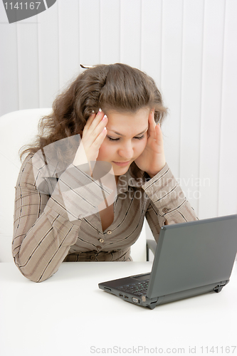 Image of tired girl with laptop