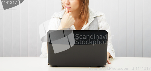 Image of pensive woman with a laptop