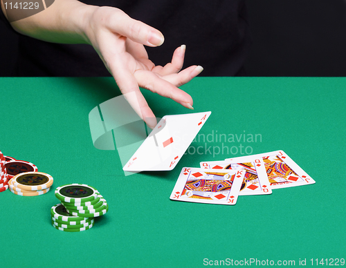 Image of female hand with a winning card combinations