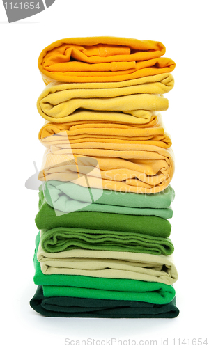 Image of Pile of green and yellow folded clothes