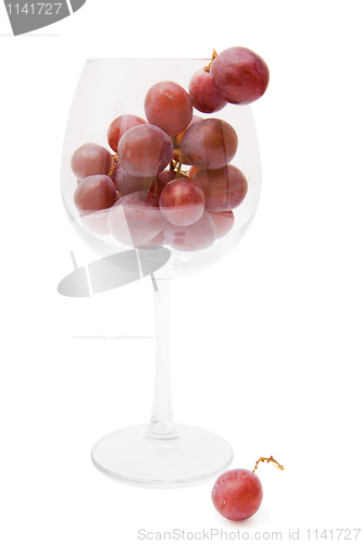 Image of red grapes in a wine glass