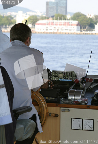 Image of Ferry captain sitting at the wheel