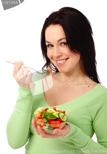 Image of Young attractive woman eats vegetable salad