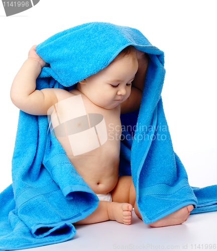 Image of Cute child wrapped in blue towel