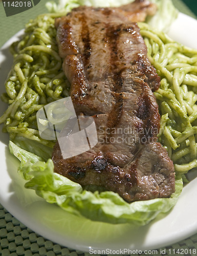 Image of green spaghetti tallarin saltado steak Peruvian food