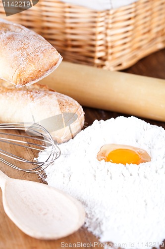 Image of still life of bread, flour, eggs and kitchen utensil 