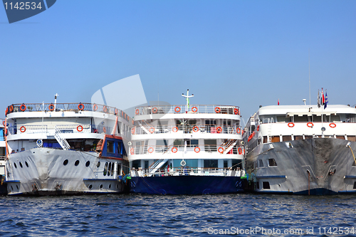 Image of three old dirty passenger ships