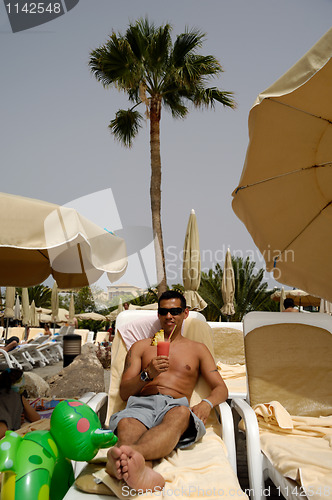 Image of Man holding drink