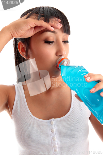 Image of Exhausted girl drinking after fitness workout