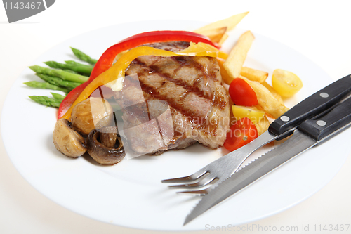 Image of Veal steak meal with cutlery