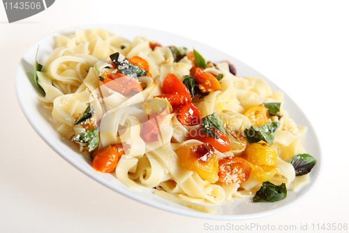 Image of Tagliatelle and tomatoes slanted