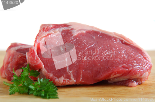 Image of Veal sirloin steaks on a board