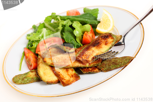 Image of Fried courgette slices and salad