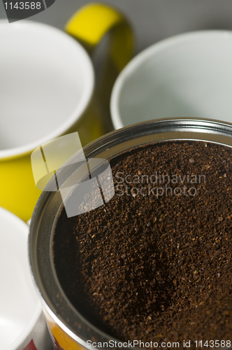 Image of can of ground coffee beans with mugs