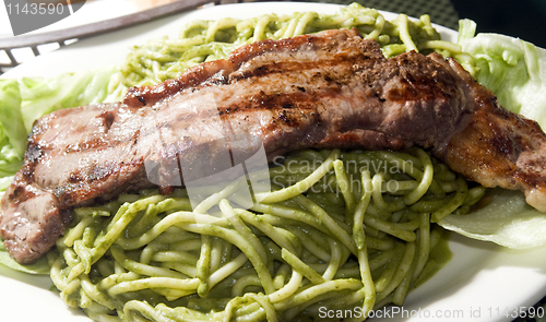 Image of green spaghetti tallarin saltado steak Peruvian food