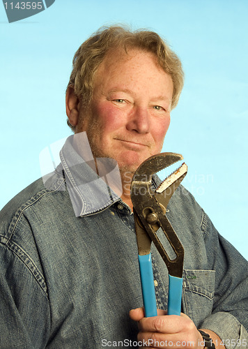 Image of smiling happy contractor builder homeowner with tool