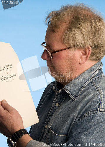 Image of middle age senior man reviewing legal last will testament docume