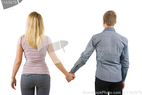 Image of A young couple holding hands, back to camera