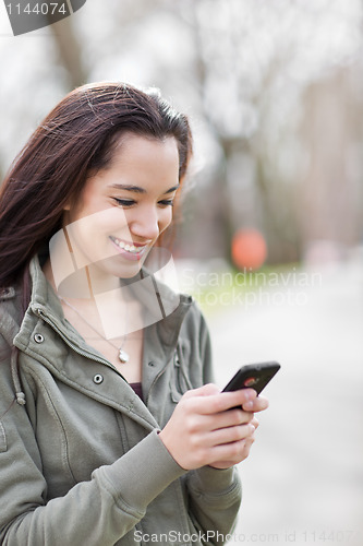 Image of Ethnic student texting