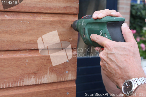 Image of Man holding power drill