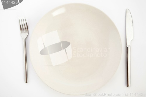 Image of Knife, white plate and fork