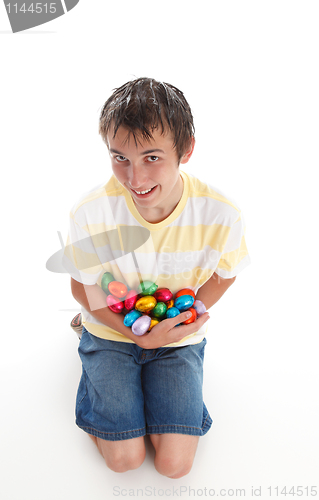 Image of Boy holding lots of easter eggs