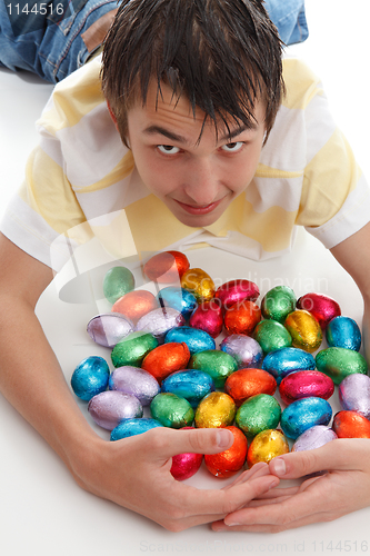 Image of Boy gathering together easter eggs