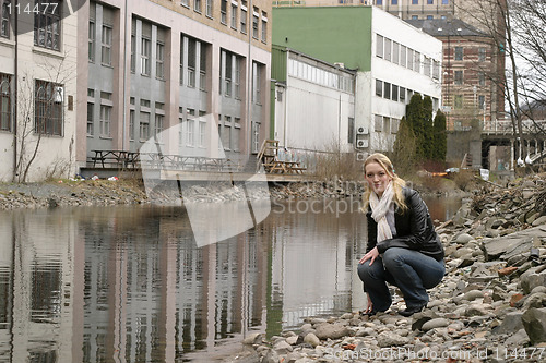 Image of Woman by City River