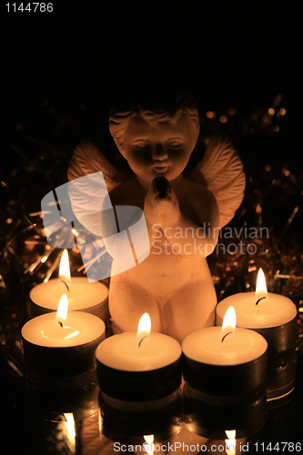 Image of Christmas angel and votive lights