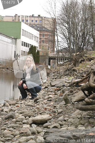 Image of Woman by City River