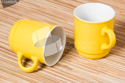 Image of Two yellow mugs on a table