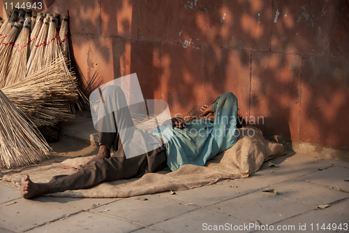 Image of Taking a nap on the street in the late evening sun.