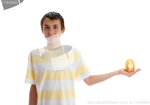 Image of Boy holding a golden easter egg