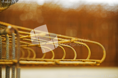 Image of concrete reinforcement with yellow background