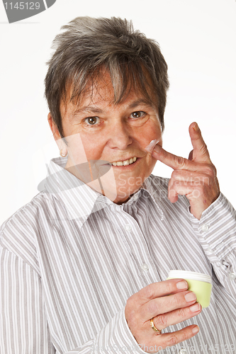 Image of Applying lotion on face