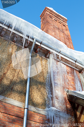 Image of Icicles Hanging From A Drainpipe On A rural House