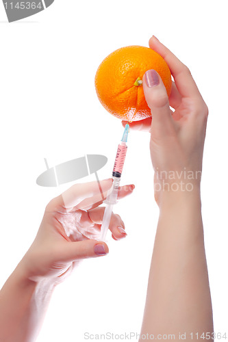 Image of woman holds in her hands medical suringe and oranges