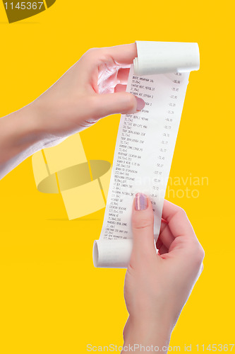 Image of woman holds in her hands roll of paper with printed receipt 