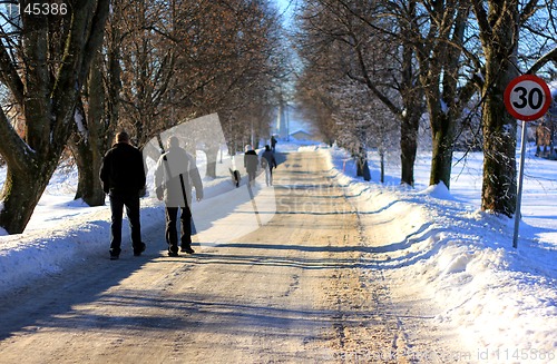 Image of People walking in a winter road.